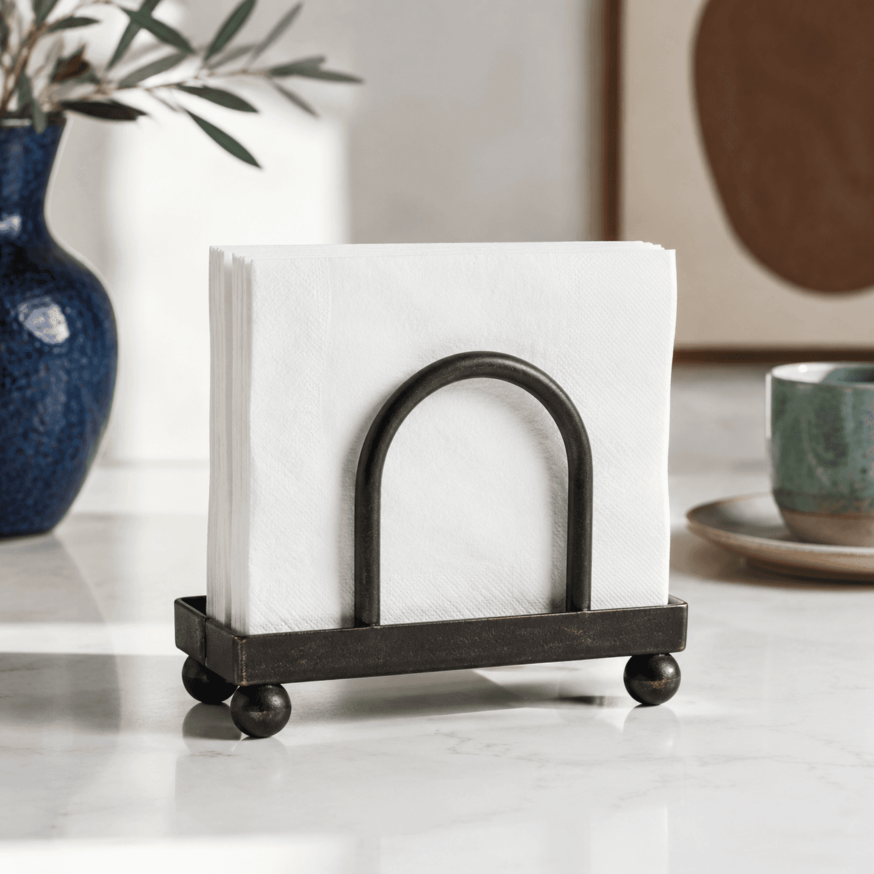 Napkin Holder — A weighted holder that keeps paper napkins upright and easy to grab.