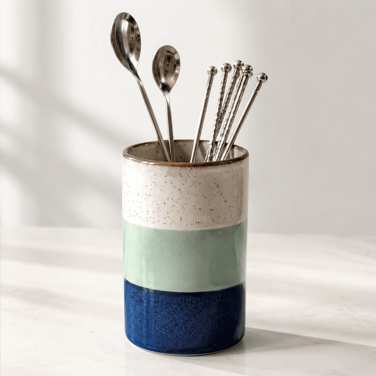 Stirrer Cup — An upright ceramic cup that holds stirrers, spoons and small tools.